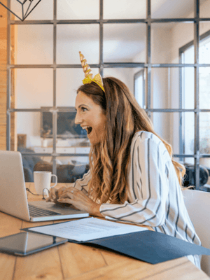 woman with a unicorn headband smiling in an office
