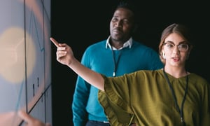 tech founders pointing at a white board